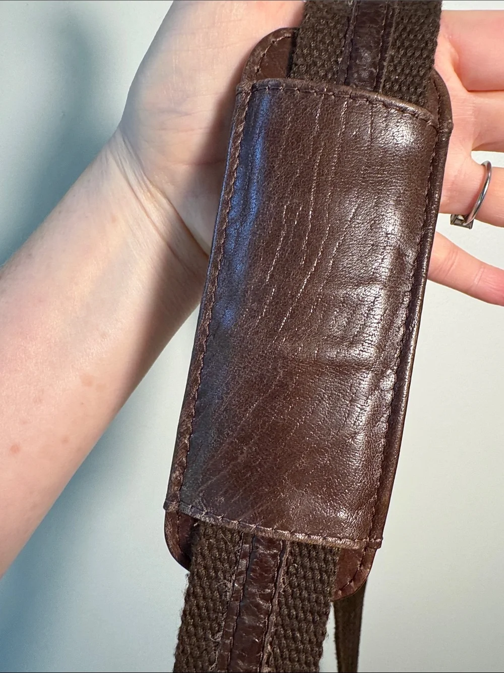Wilson’s Leather chocolate brown messenger bag with webbed adjustable strap.